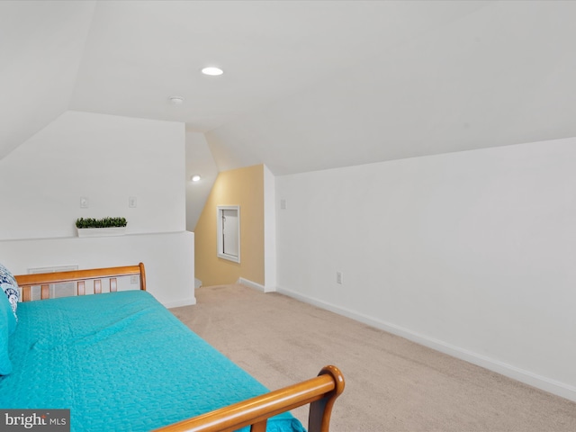 carpeted bedroom featuring lofted ceiling