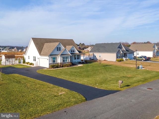 view of front of property featuring a garage and a front lawn