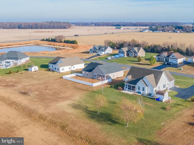 birds eye view of property with a water view and a rural view