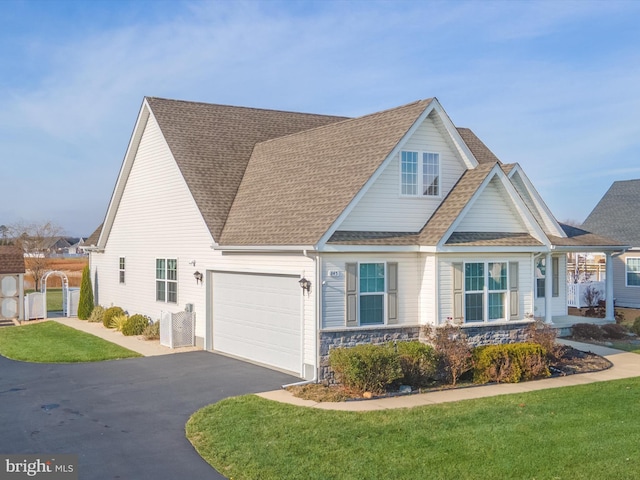 view of front of home with a garage and a front yard