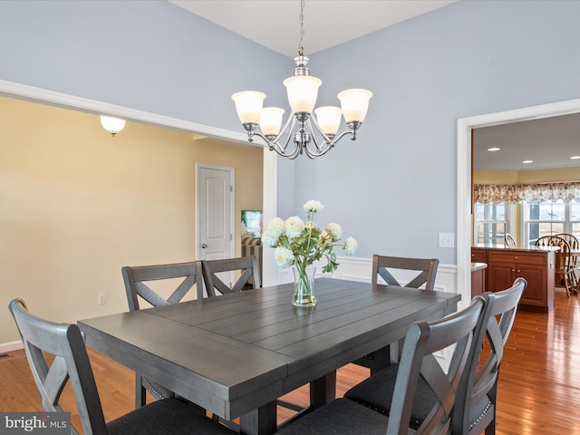 dining area featuring an inviting chandelier and hardwood / wood-style floors