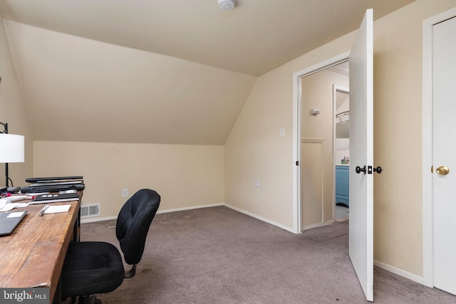 carpeted office space featuring lofted ceiling