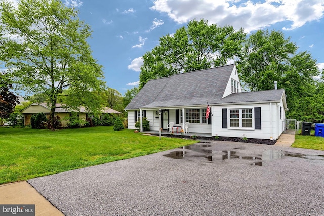 view of front of home featuring covered porch and a front yard