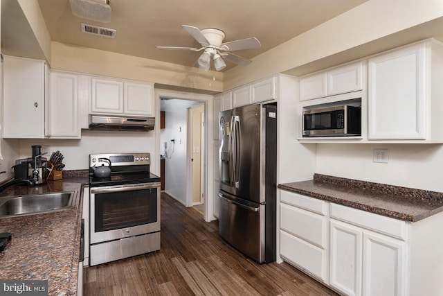 kitchen with dark wood-type flooring, sink, white cabinets, and stainless steel appliances