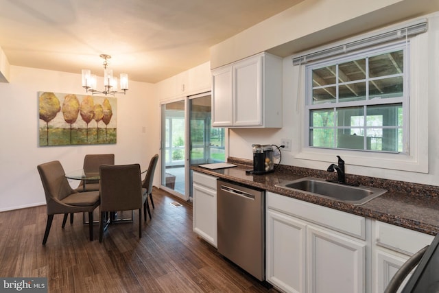 kitchen featuring stainless steel dishwasher, sink, decorative light fixtures, white cabinets, and plenty of natural light