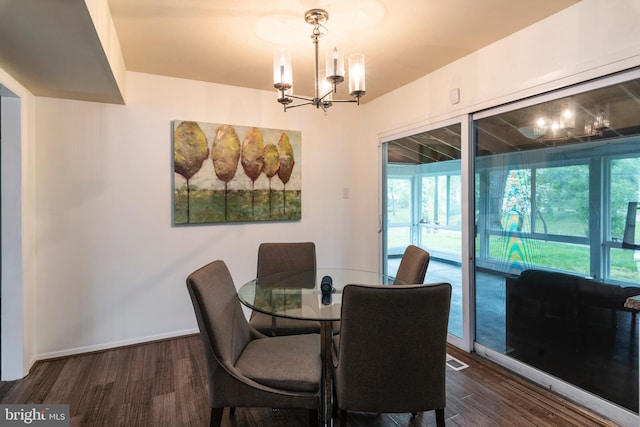 dining room featuring a chandelier and dark hardwood / wood-style floors