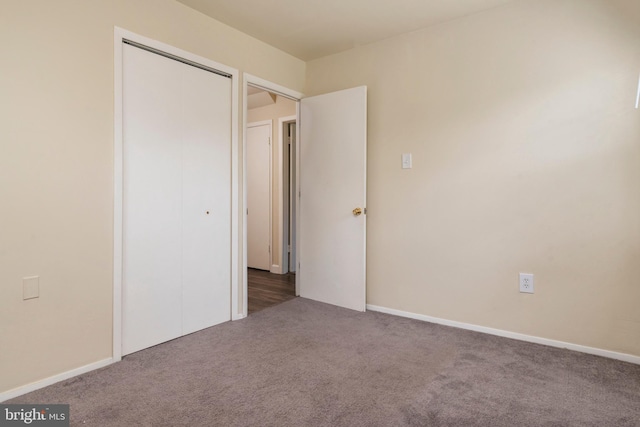 unfurnished bedroom with carpet floors and a closet