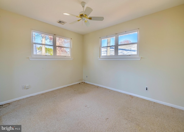 unfurnished room featuring carpet flooring, ceiling fan, and a healthy amount of sunlight