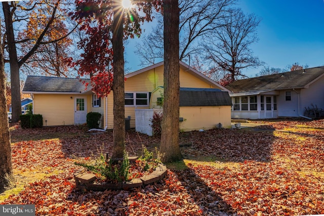 view of property exterior with a sunroom