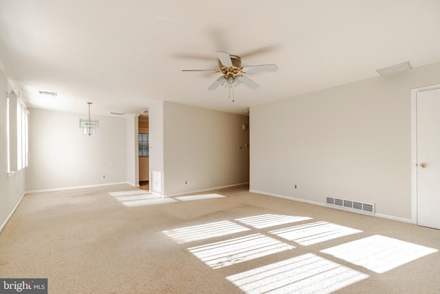 carpeted spare room with ceiling fan