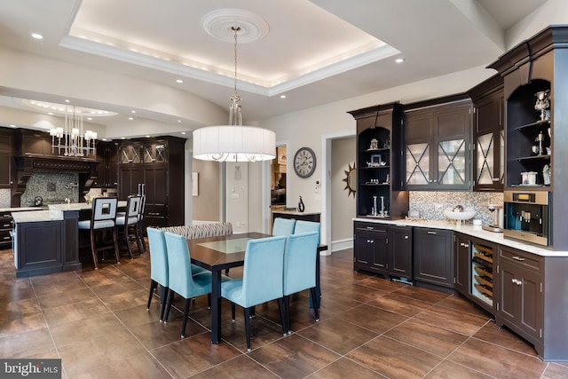 dining space with a tray ceiling and beverage cooler