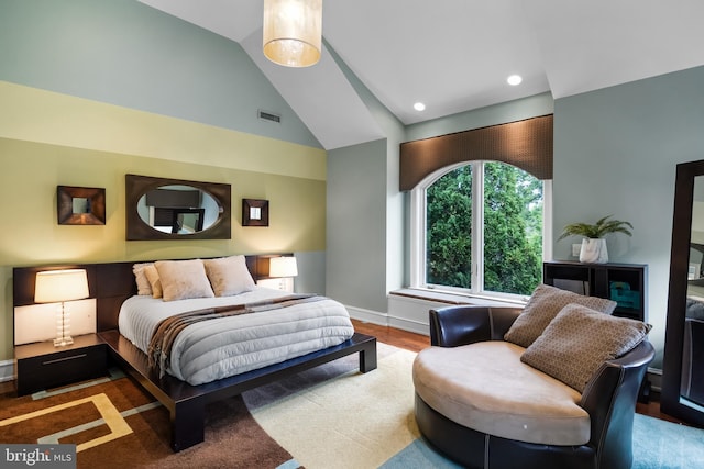 bedroom with hardwood / wood-style floors and vaulted ceiling