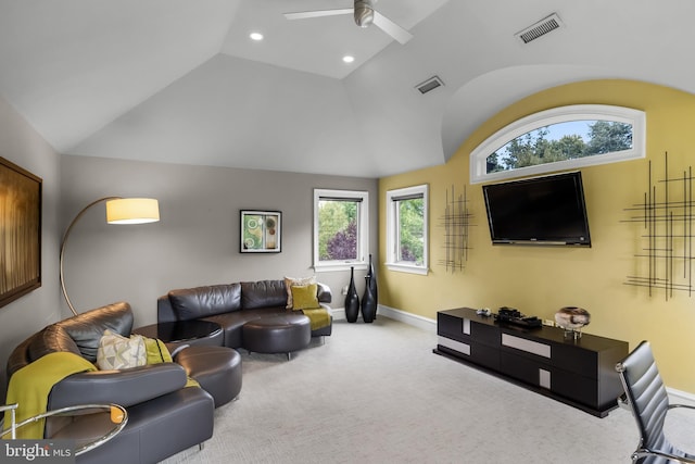 carpeted living room with vaulted ceiling, plenty of natural light, and ceiling fan