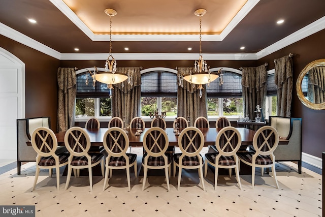 dining room with ornamental molding and a tray ceiling