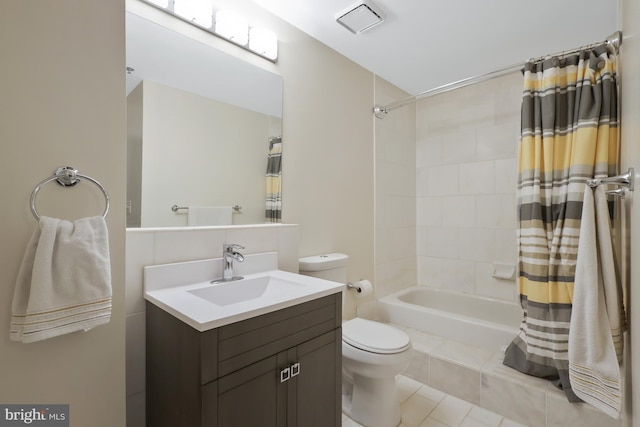 full bathroom with vanity, toilet, and shower / bath combo with shower curtain