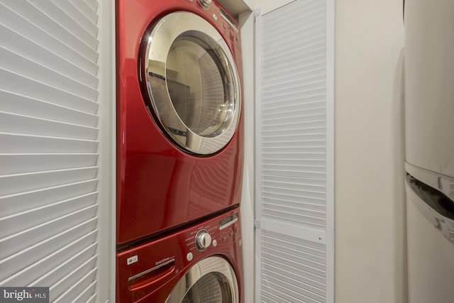 laundry area with stacked washing maching and dryer