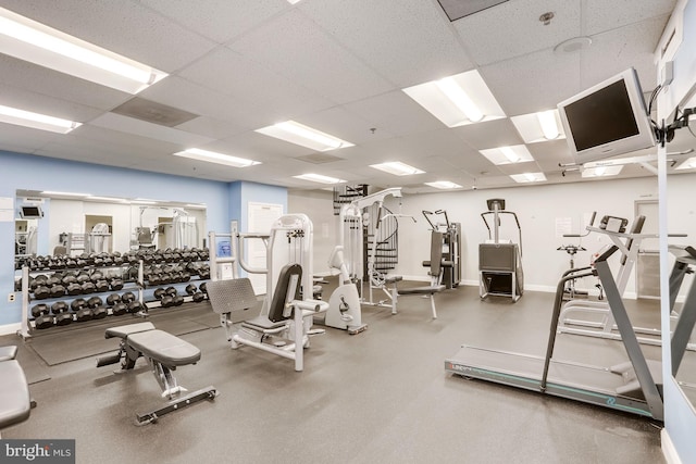 exercise room with a paneled ceiling