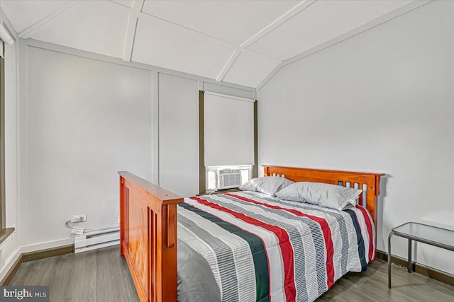 bedroom with cooling unit, a baseboard radiator, and dark hardwood / wood-style floors