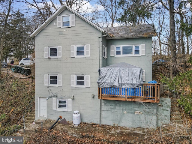 rear view of house featuring a deck