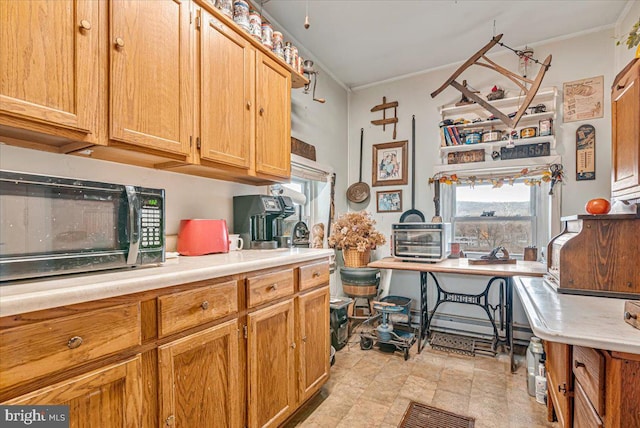 5449 Depues Rd, Bangor, PA 18013 - kitchen with stainless steel microwave, crown molding, light countertops, and plenty of natural light