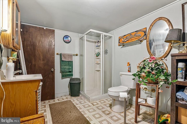 bathroom with vanity, toilet, and a shower with shower door