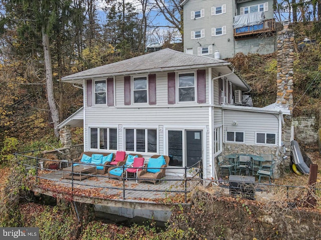 rear view of house with an outdoor hangout area