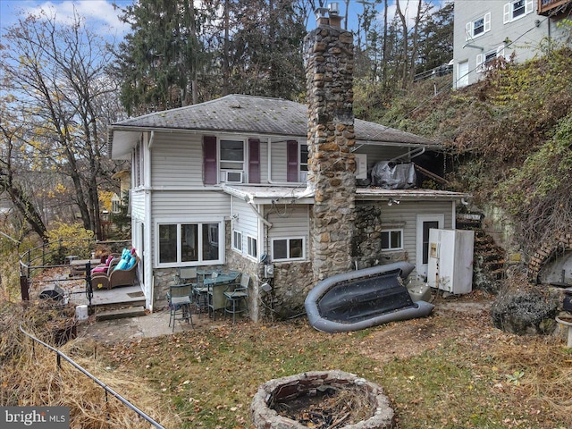 rear view of house featuring cooling unit and a patio area