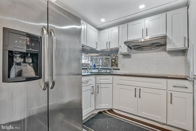 kitchen with white cabinets, stainless steel fridge, and sink