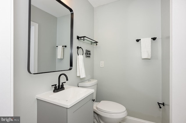 bathroom featuring toilet and vanity