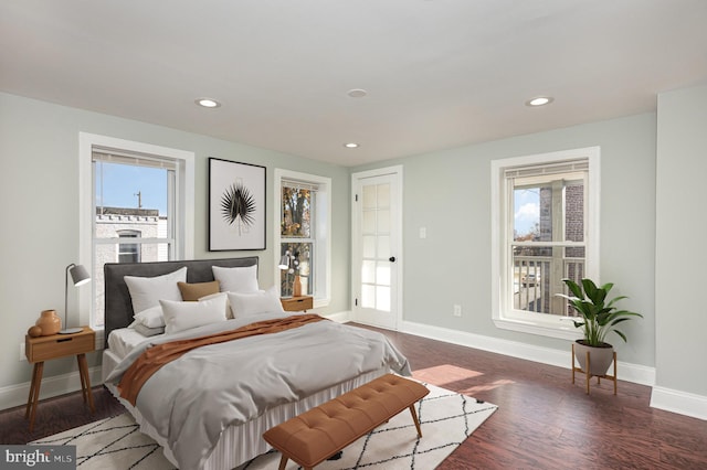 bedroom featuring dark hardwood / wood-style flooring and multiple windows