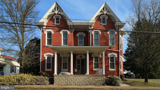 view of front of home with covered porch and cooling unit