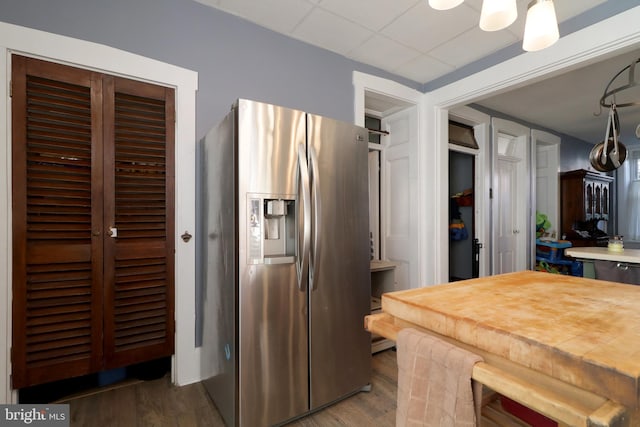 kitchen with stainless steel fridge and dark hardwood / wood-style floors