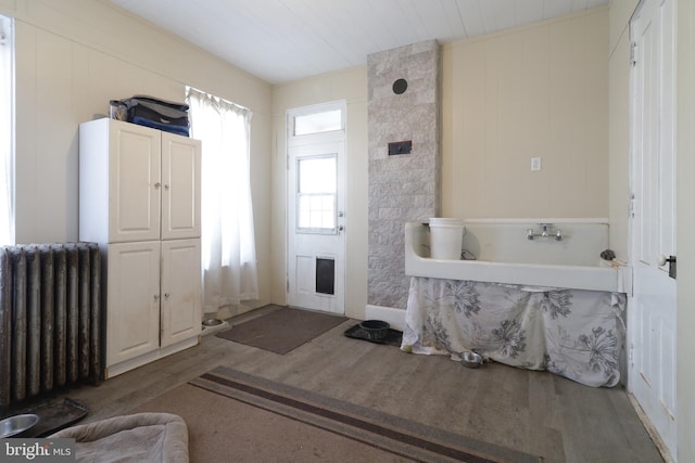 bathroom featuring hardwood / wood-style floors, wood ceiling, and radiator