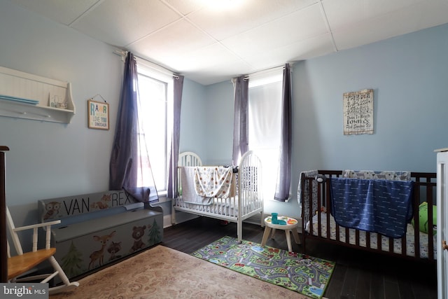 bedroom with dark wood-type flooring