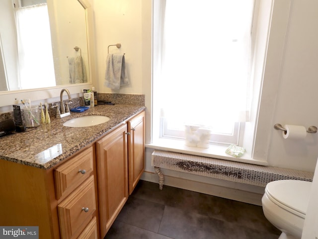 bathroom with tile patterned floors, vanity, and toilet