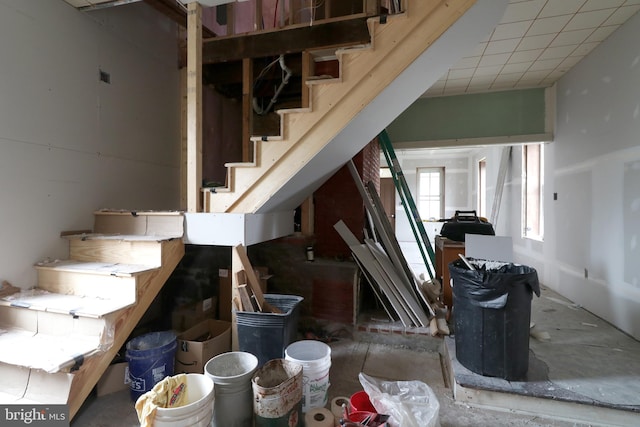 stairs featuring concrete flooring