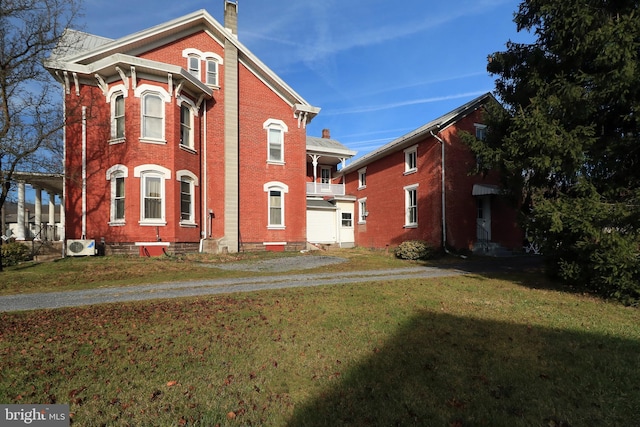 exterior space with ac unit and a yard