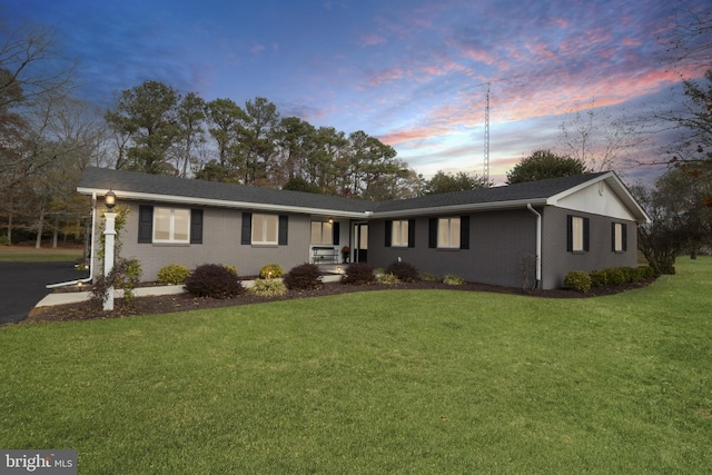 ranch-style house featuring a lawn