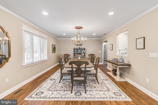 dining space featuring a notable chandelier, crown molding, and dark wood-type flooring