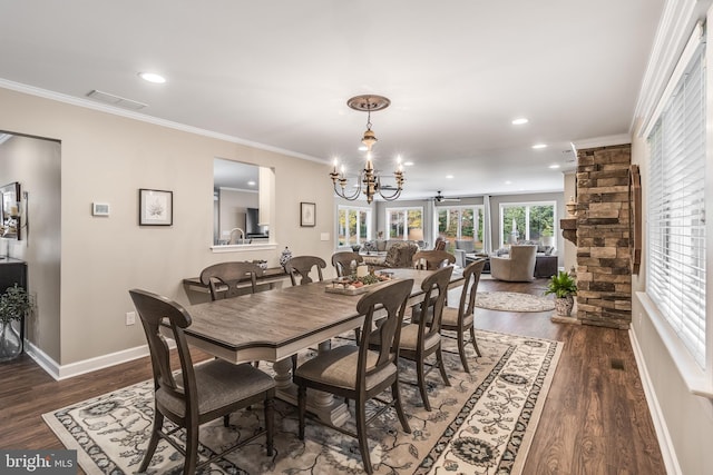 dining room featuring an inviting chandelier, dark hardwood / wood-style floors, and ornamental molding