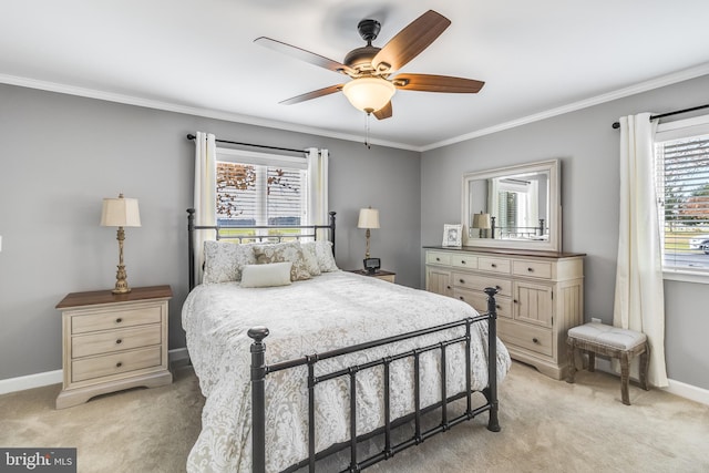 carpeted bedroom featuring ceiling fan and crown molding