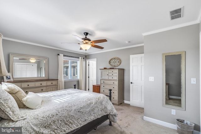 carpeted bedroom featuring ceiling fan and ornamental molding