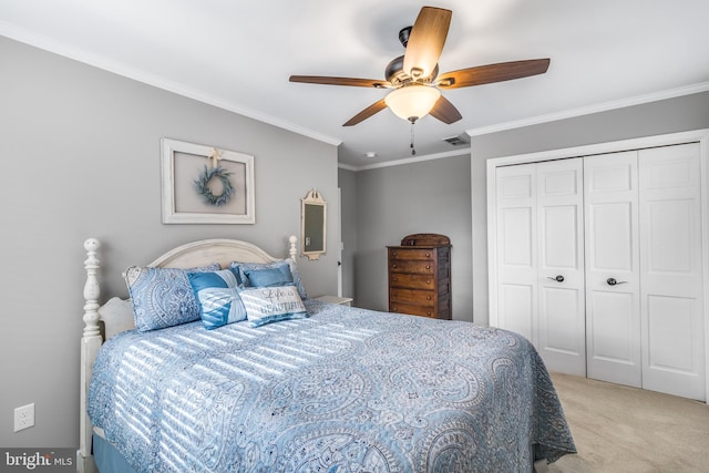 bedroom with ceiling fan, crown molding, light carpet, and a closet