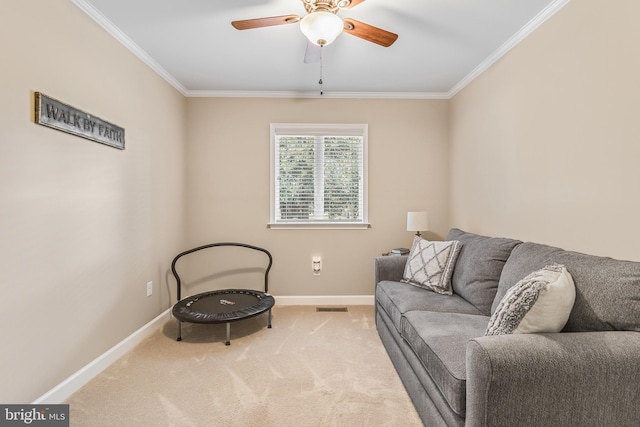 sitting room featuring carpet, ceiling fan, and ornamental molding