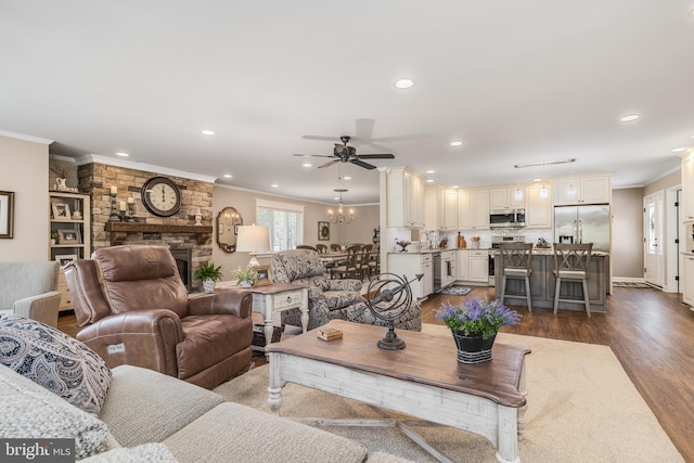 living room featuring a fireplace, ceiling fan, dark hardwood / wood-style flooring, and ornamental molding