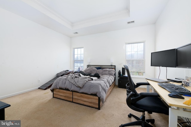 bedroom with a raised ceiling, ornamental molding, and light carpet