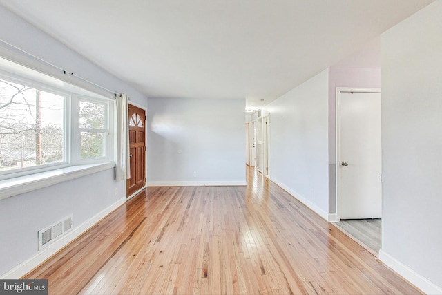 unfurnished room with light hardwood / wood-style floors