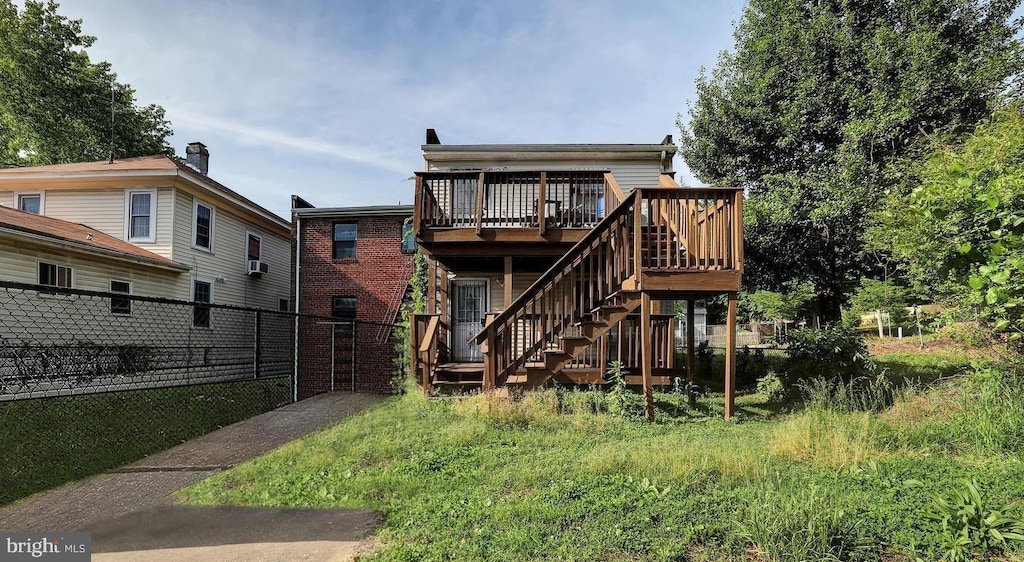 back of house featuring a deck and cooling unit