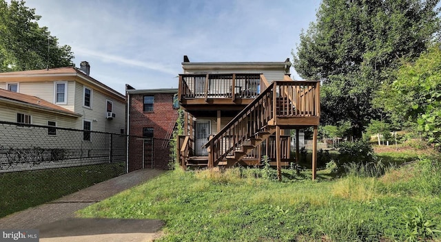 back of house featuring a deck and cooling unit