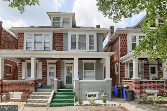 townhome / multi-family property featuring covered porch